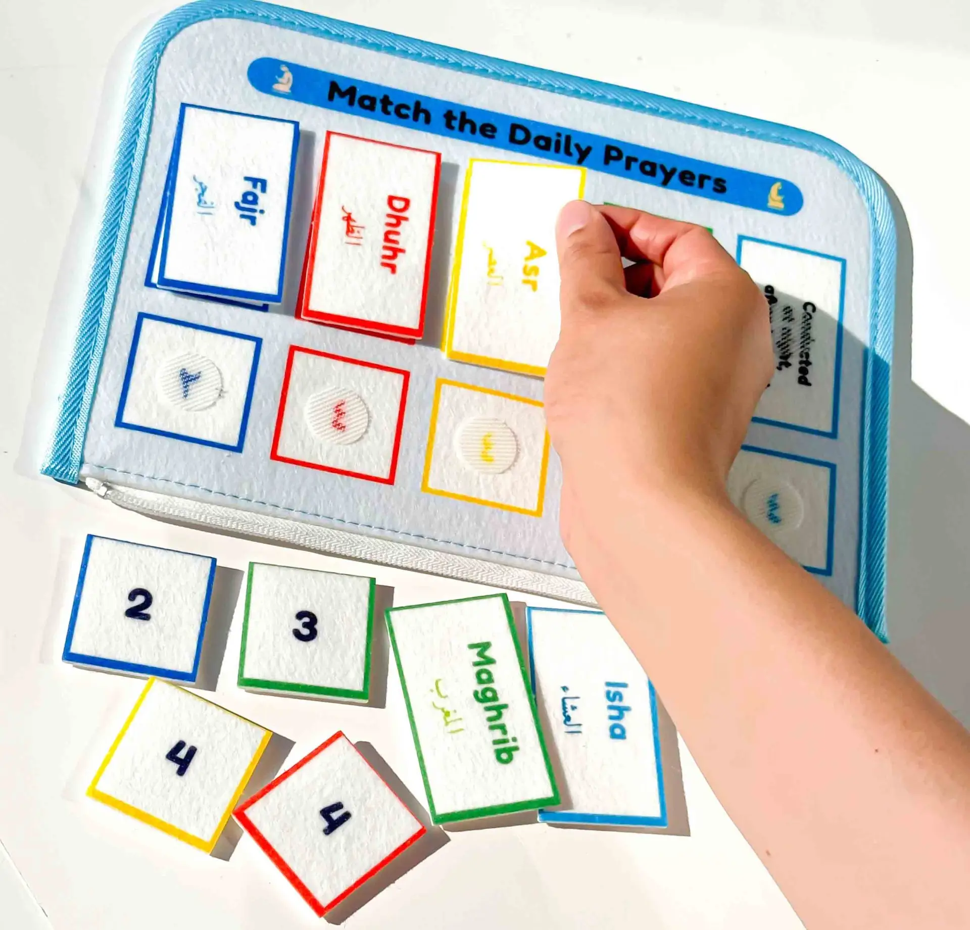 Happy child playing with Islamic Quiet Book